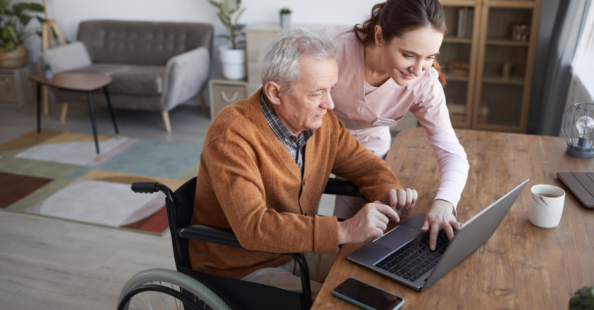 Man in wheelchair using laptop