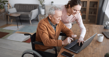 Man in wheelchair using laptop