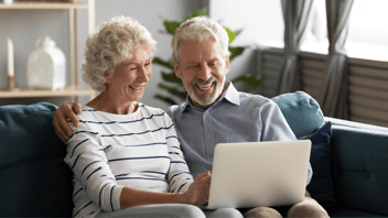 older couple using laptop at home