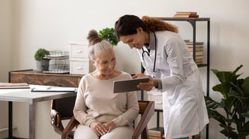 clinician showing a patient information on social prescribing